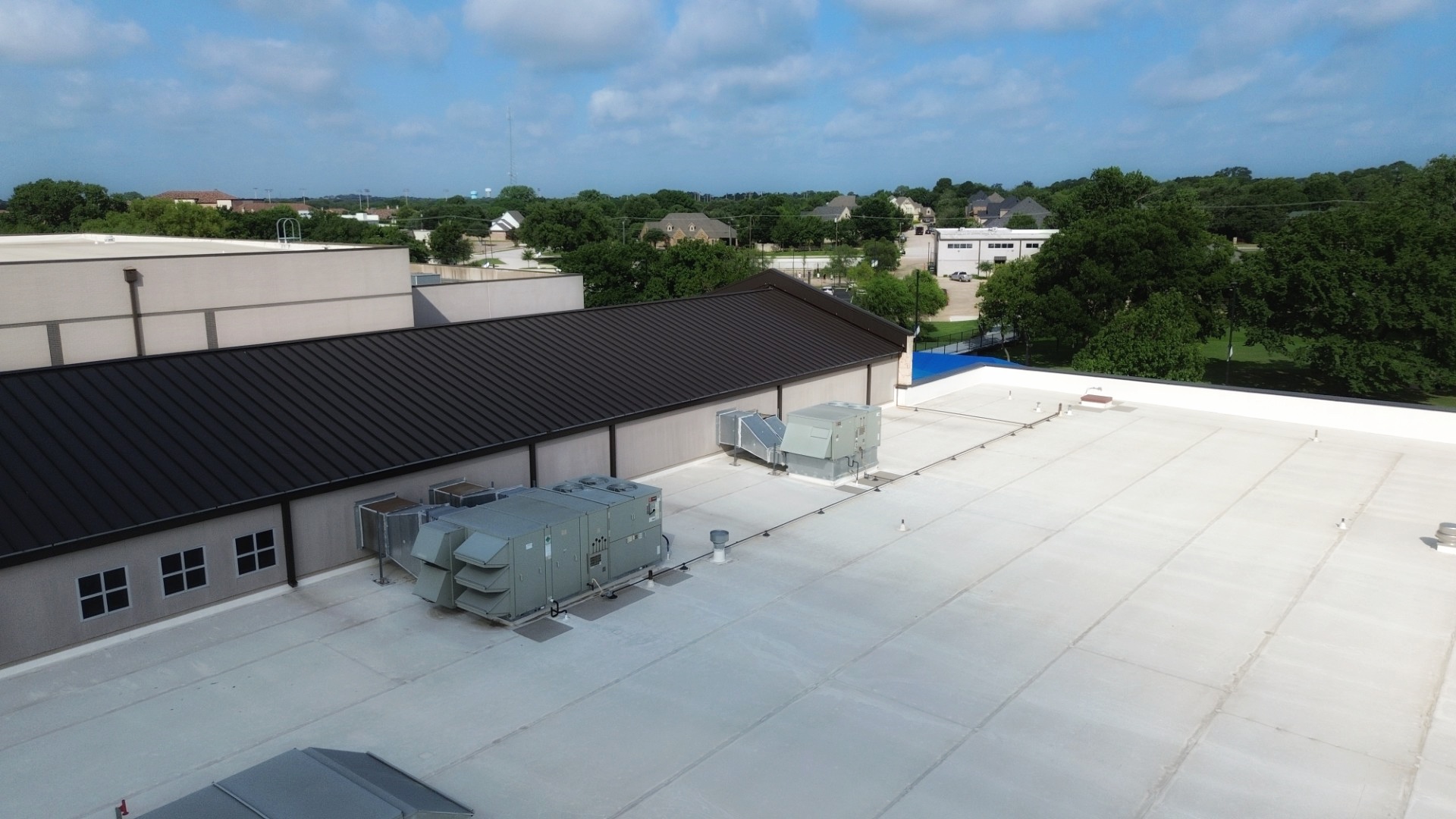 Featured Commercial Roofing Project with a mix of a metal and a flat roof.