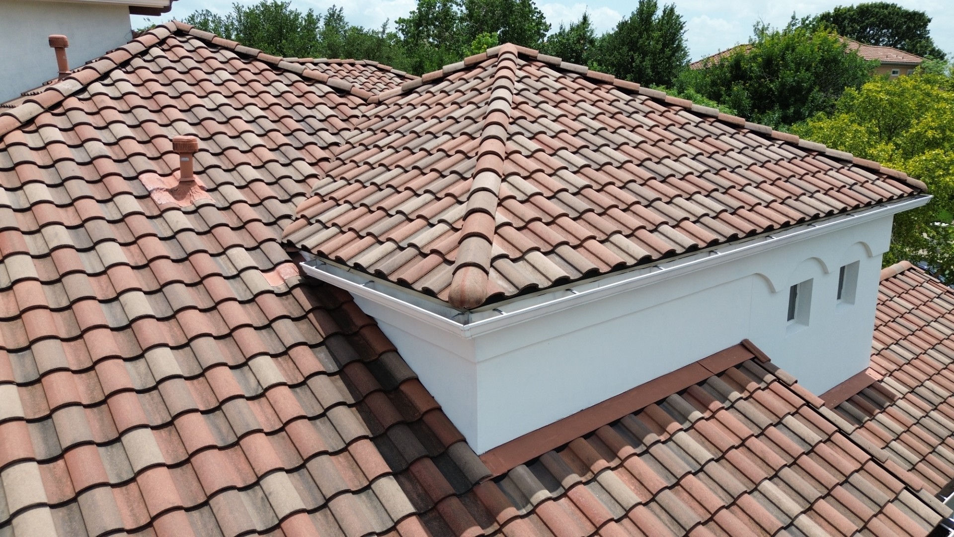 Specialty residential roofing project with a clay tile roof.